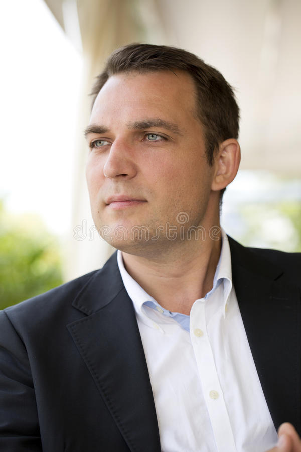 portrait-young-business-man-dark-suit-white-shirt-close-up-56420816